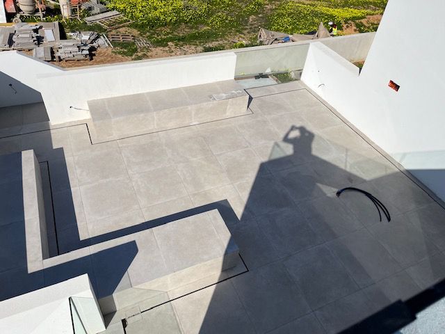 Outdoor terrace and steps with finishing work in progress at Porto de Mós