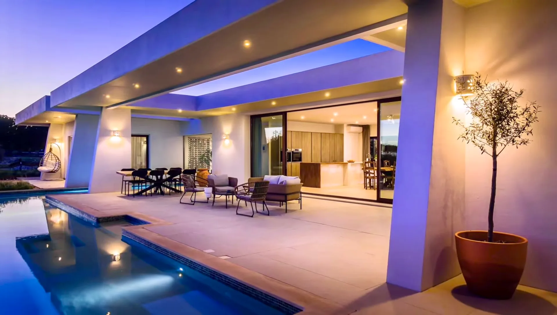 Illuminated covered terrace beside the Villa Porches pool