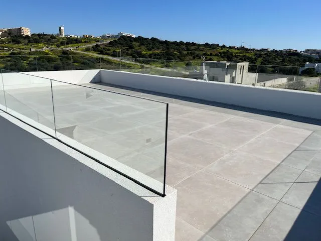 Tiled rooftop terrace with glass balustrades at Porto de Mós, Lagos
