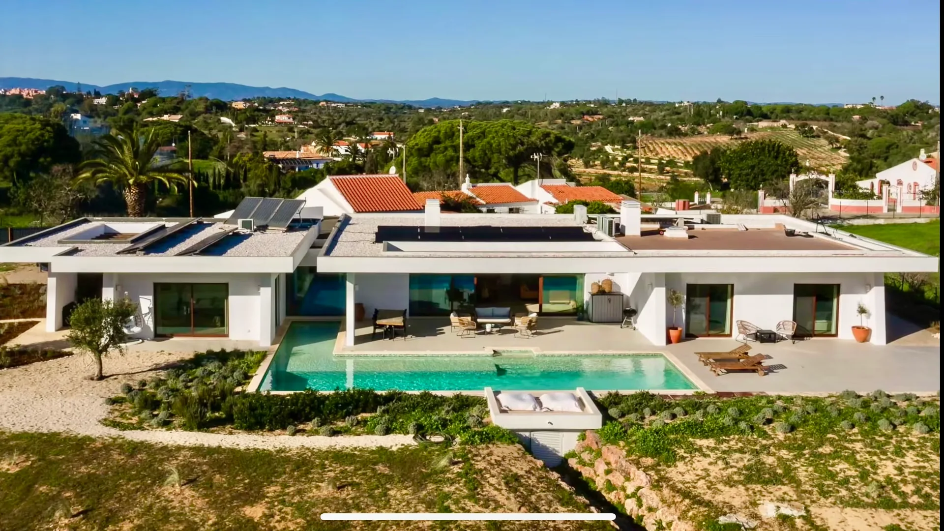Aerial view of Villa Porches, its pool and surrounding landscape