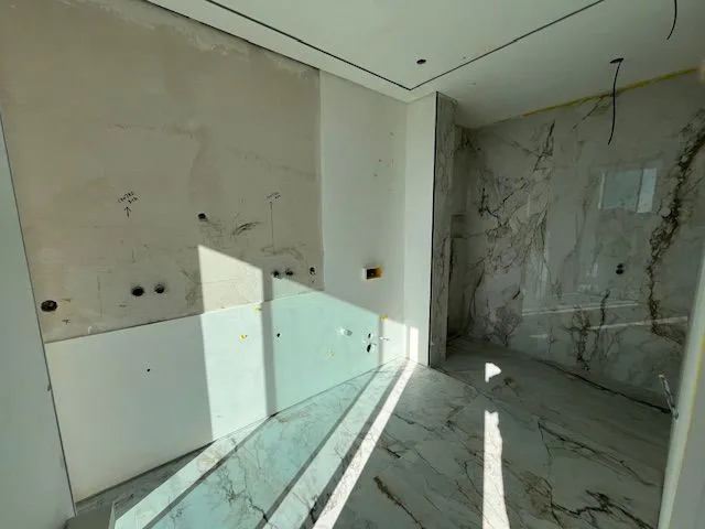 Bathroom with unfinished fittings and glass panels at Porto de Mós, Lagos