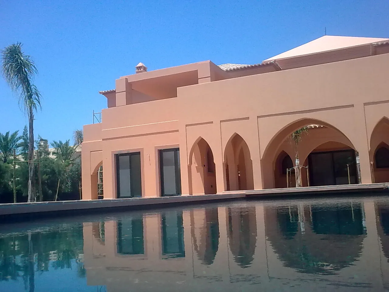Villa Kasbah's Moorish-style facade and arched terrace beside the pool, Algarve