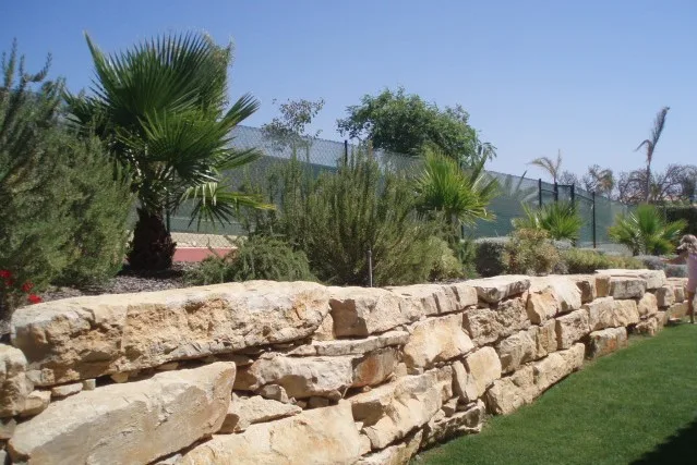 Stone retaining wall and landscaped garden at Quinta do Monte Funchal, Lagos