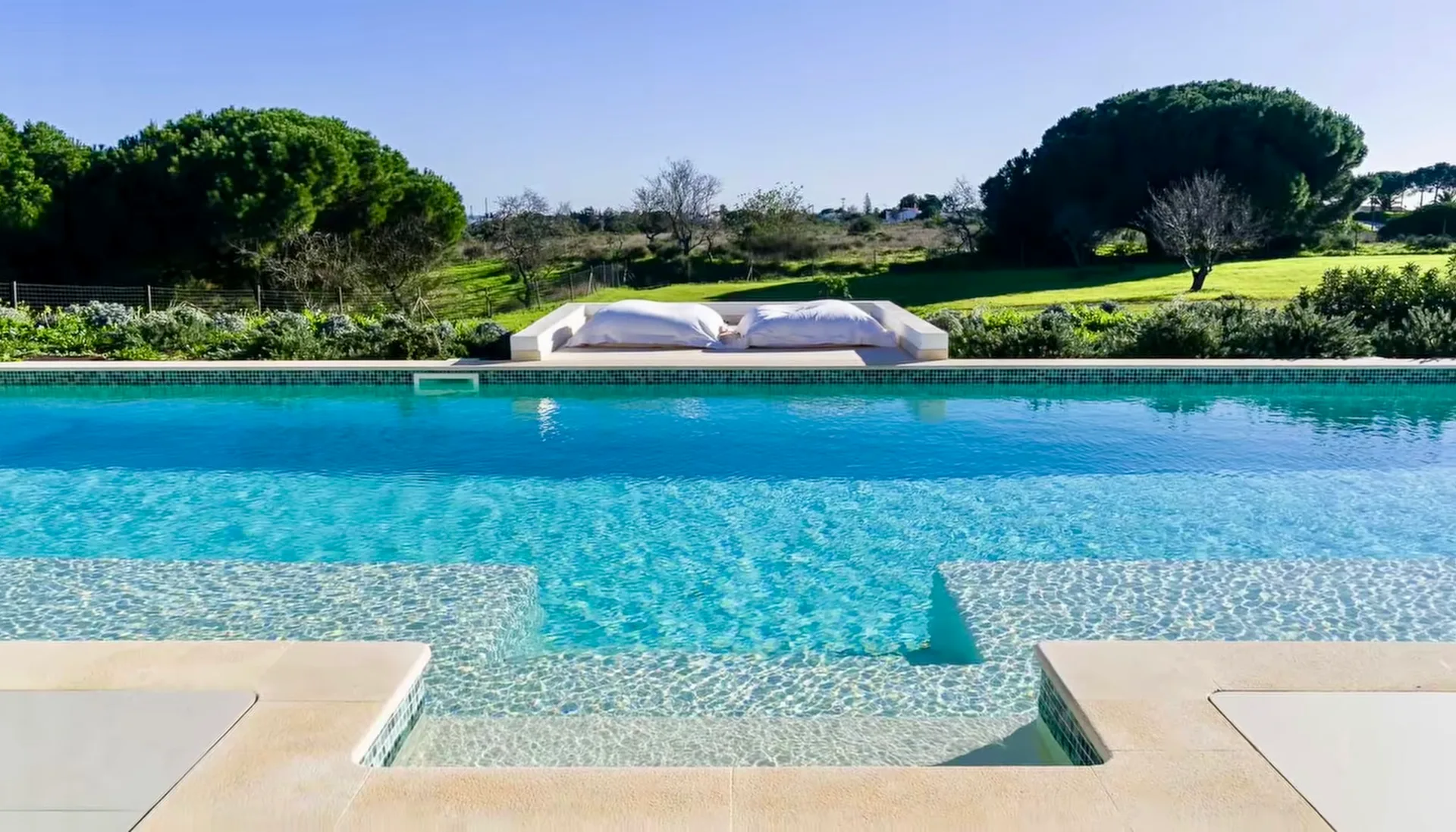 Villa Porches pool overlooking the lawn and surrounding trees