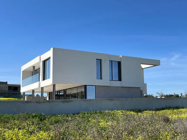 Porto de Mós villa exterior viewed across neighbouring vegetation, Lagos