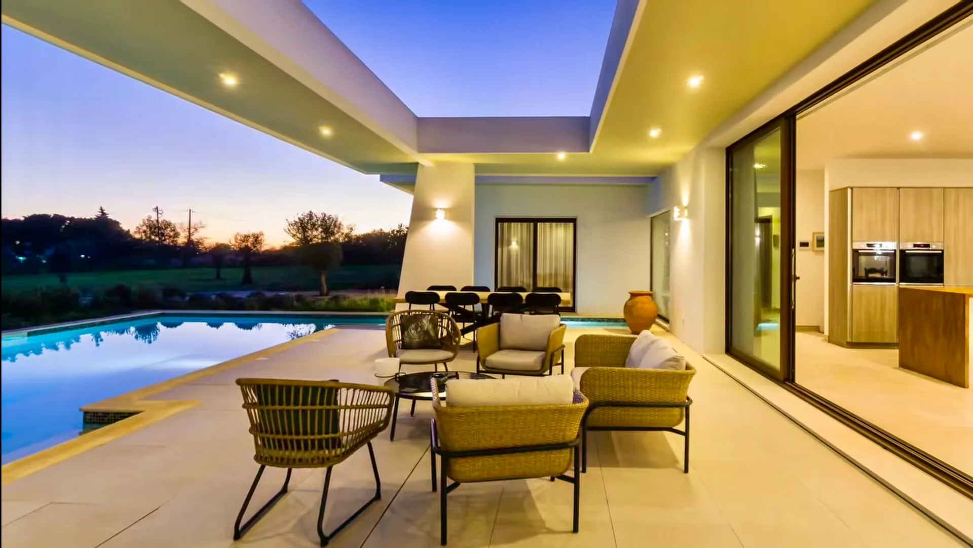 Covered seating area beside the Villa Porches pool at sunset