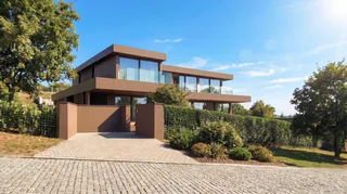 Rendering of the timber-clad villa among landscaped gardens at Palmares — LT73